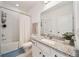 Bright bathroom featuring a shower-tub combo, granite vanity top and white cabinets at 704 Hyperion Dr, Debary, FL 32713