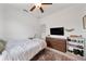 Bright bedroom featuring a ceiling fan, TV atop dresser, and a decorative rug at 704 Hyperion Dr, Debary, FL 32713