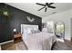 Cozy bedroom featuring a dark accent wall and ensuite bathroom access at 704 Hyperion Dr, Debary, FL 32713