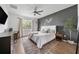 Modern bedroom showcasing a dark accent wall, hardwood floors, and natural light at 704 Hyperion Dr, Debary, FL 32713