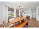 Inviting dining area with a wooden table, bench, and large windows, offering a bright and comfortable space at 704 Hyperion Dr, Debary, FL 32713