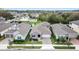 Aerial view of a well-manicured single-Gathering home featuring a paver driveway and mature landscaping at 704 Hyperion Dr, Debary, FL 32713