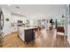 Open-concept kitchen with a large island, white cabinets, stainless steel appliances, and seamless flow into the dining area at 704 Hyperion Dr, Debary, FL 32713