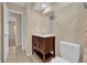 Bathroom featuring a wood vanity with drawers, a mirror, and a nearby toilet at 7448 Grand Ct, Winter Park, FL 32792