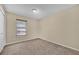 This carpeted bedroom features a single window at 7448 Grand Ct, Winter Park, FL 32792