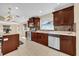 Bright kitchen with stainless steel appliances, tiled backsplash, and peninsula with seating at 7448 Grand Ct, Winter Park, FL 32792