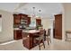 Stylish kitchen with a central island, dark wood cabinets, and modern lighting fixtures at 7448 Grand Ct, Winter Park, FL 32792