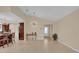 Bright and airy living space featuring tiled floors, modern lighting, and seamless kitchen access at 7448 Grand Ct, Winter Park, FL 32792