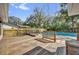 Large wooden deck leading to an inviting inground pool surrounded by mature trees at 7448 Grand Ct, Winter Park, FL 32792