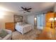 Charming bedroom with a ceiling fan, queen bed, and double closets at 7449 Sugar Bend Dr # 7449, Orlando, FL 32819