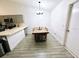 Bright dining area showcases wood-look tile floors, a long wooden table, and a modern chandelier at 7885 Brockwood Cir, Orlando, FL 32822