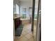 Bathroom featuring double vanity, soaking tub, glass shower, earth toned tiled floors and coordinated bath towels at 8744 Currituck Sound Ln, Orlando, FL 32829