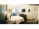 Bedroom featuring dark wood floors, a white bed, a TV and neutral walls at 8744 Currituck Sound Ln, Orlando, FL 32829