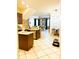 Open-concept kitchen flowing into the dining area, featuring tile flooring and stainless steel appliances at 8744 Currituck Sound Ln, Orlando, FL 32829