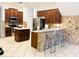 Spacious kitchen featuring dark wood cabinets, a center island, and a cozy breakfast bar with stools at 8744 Currituck Sound Ln, Orlando, FL 32829