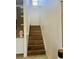 Staircase featuring wooden stairs, white banister, and natural light from a window at the top at 8744 Currituck Sound Ln, Orlando, FL 32829