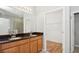 Bathroom featuring a double sink vanity with granite countertops and a walk-in closet at 981 Galway Blvd, Apopka, FL 32703