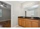 Bathroom featuring double sink vanity with granite countertops and updated lighting fixtures at 981 Galway Blvd, Apopka, FL 32703