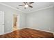 Bedroom with hardwood floors, a ceiling fan, and access to an ensuite bathroom at 981 Galway Blvd, Apopka, FL 32703