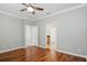 Bedroom with wood floors, a ceiling fan, and access to an ensuite bathroom at 981 Galway Blvd, Apopka, FL 32703