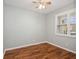 Bedroom featuring updated laminate flooring and a window with plantation shutters at 981 Galway Blvd, Apopka, FL 32703