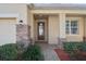 Covered front porch with stone accents, decorative plants, and a brick walkway leading to the entrance at 981 Galway Blvd, Apopka, FL 32703