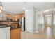 Open kitchen featuring granite countertops, stainless steel appliances, and light wood cabinetry, with a view of the entry at 981 Galway Blvd, Apopka, FL 32703