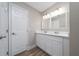 Stylish bathroom featuring a double vanity with modern fixtures and a large mirror at 986 Sweetbrier Dr, Deltona, FL 32725