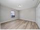 Bright bedroom featuring wood-look floors, neutral walls, and a built in closet at 986 Sweetbrier Dr, Deltona, FL 32725