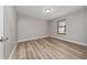 Bedroom featuring wood-look floors, neutral walls, and natural light from a single window at 986 Sweetbrier Dr, Deltona, FL 32725