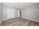 Bedroom with wood-look floors, neutral walls, and closet with sliding doors at 986 Sweetbrier Dr, Deltona, FL 32725