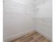 Walk-in closet with wire shelving and wood-look floors at 986 Sweetbrier Dr, Deltona, FL 32725