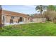 Backyard featuring a kidney-shaped swimming pool, seating, grass, and patio area at 1010 Corbin Ct, Oviedo, FL 32765
