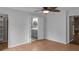 Bright bedroom with ceiling fan, wood floors, and ensuite bathroom at 1010 Corbin Ct, Oviedo, FL 32765