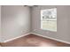 This bedroom featuring wood floors and a window letting in natural light at 1010 Corbin Ct, Oviedo, FL 32765