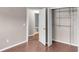 Neutral bedroom with a closet and bathroom view featuring wood-look flooring and ample natural light at 1010 Corbin Ct, Oviedo, FL 32765