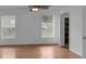This is a bright bedroom featuring two windows, wood floors, and a closet at 1010 Corbin Ct, Oviedo, FL 32765