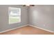 This is an empty bedroom with wood floors and a window letting in natural light at 1010 Corbin Ct, Oviedo, FL 32765