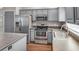 Modern gray kitchen featuring stainless steel appliances and ample counter space at 1010 Corbin Ct, Oviedo, FL 32765