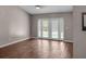 Bright living room with wood floors and elegant glass doors leading to the pool area at 1010 Corbin Ct, Oviedo, FL 32765