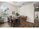 Dining area with a large window, modern chandelier, and stylish wooden furniture at 1061 New Castle Ln, Oviedo, FL 32765