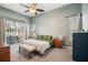 Comfortable main bedroom with a ceiling fan, carpet, and a sliding glass door to the patio at 1061 New Castle Ln, Oviedo, FL 32765