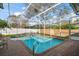 Screened-in pool area featuring brick patio, white fencing and comfortable seating for relaxation at 1061 New Castle Ln, Oviedo, FL 32765