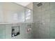 Close-up of a tiled shower with a glass partition and niche shelving, showcasing modern bathroom design at 1061 New Castle Ln, Oviedo, FL 32765