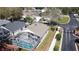 Aerial view of a home with a screened pool, set among other homes in the neighborhood at 109 Grosvenor Loop, Davenport, FL 33897