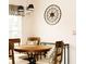 Charming dining area featuring a round wooden table and decorative wall art at 109 Grosvenor Loop, Davenport, FL 33897