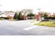 Community entrance with brick pillars, iron gates, mature landscaping, and neighborhood signage at 109 Grosvenor Loop, Davenport, FL 33897