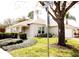 Beautifully landscaped yard with mature trees surrounding a charming single-story home at 109 Grosvenor Loop, Davenport, FL 33897