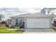 Charming single-story home featuring a two-car garage and well-maintained landscaping at 109 Grosvenor Loop, Davenport, FL 33897