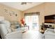 Cozy living room with comfortable seating and sliding glass doors to the patio at 109 Grosvenor Loop, Davenport, FL 33897